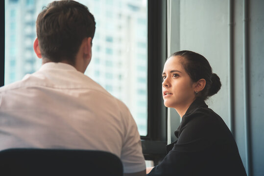 Young businesswoman discussing with businessman at office.