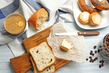 Composition with tasty butter coffee on wooden table