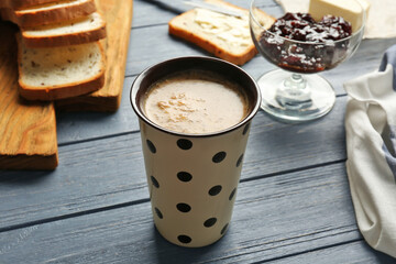 Cup of tasty butter coffee on wooden table