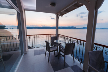 Cafe bar terrace, view at Mediterranean sea. Evening scenery, Ormos Navarinou harbor, Pilos town, Greece.