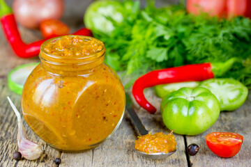 Vegetable caviar from green tomatoes, chili pepper, cherry tomatoes, onion, garlic, parsley