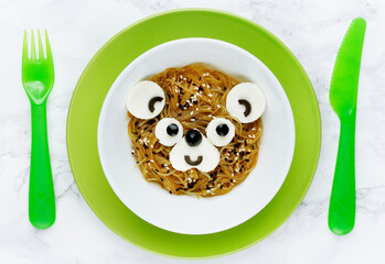 Food art idea for kids - bear pasta from yakisoba, olive and tofu cheese © san_ta