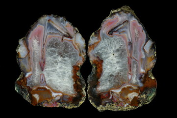A cross section of the agate stone. Agate with pseudomorphosis and crystalline quartz. Multicolored silica bands colored with metal oxides are visible. Origin: Asni, Atlas Mountains, Morocco.