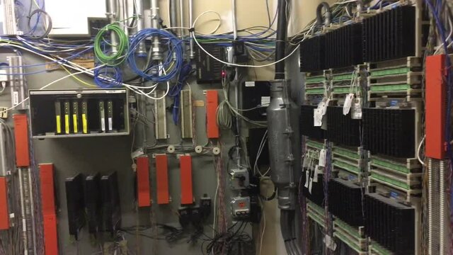 Large network nerve center in expansive office complex panned slowly from right to left. 
