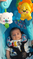 baby boy in blue puschair wit spining toys