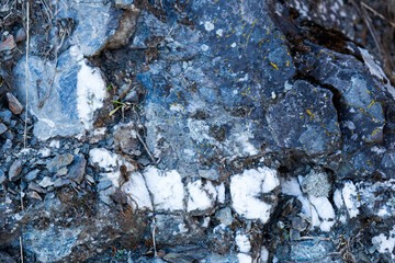 white speckled grey stone with rust closeup texture background nature
