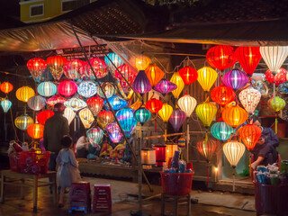 Lantern seller in the streets of ancient town of Hoi An in Central Vietnam, colorful lanterns hanging everywhere creating a great atmosphere © jzajic