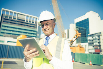 Construction manager controlling building site and tablet device