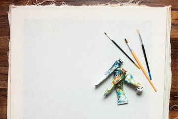 Professional painter workplace flat lay. Oil paints, brushes, canvas. Artist's equipment assortment background. Drawing lessons, art school, young painter, creativity, DIY concept