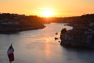 Seagull watching the reflection of the sun at river Douro, seen from Ponte Luis at Sunset - Porto,...