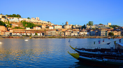 Fototapeta na wymiar Boats in clear blue water during sunset, seen from Ribeira, Porto, Portugal
