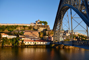 Fototapeta na wymiar Reflection of the sun at river Douro and city during Sunset, seen from Ponte Luis at Sunset - Porto, Portugal