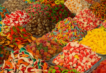 Collection of colorful gummy candies at market. Top view. Close-up