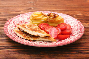 Fried turkey fillets, roasted potatoes and cherry tomato