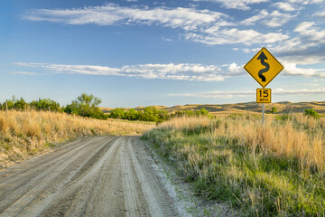sandy ranch road descending into a valley of DIsmal RIver in Nebraska Sand Hills near Seneca,...