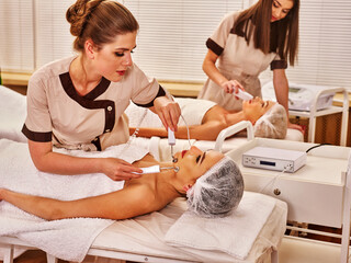 Couple facial massage beauty salon. Electric stimulation woman and man skin care . Equipment...
