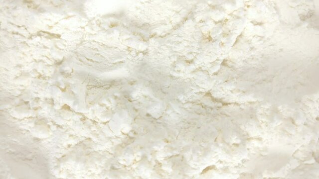 Great background of white Wheat Flour rotating close up. Footage will work great for any videos dealing homemade baking, bakeshop, family traditions, hospitality and much more.