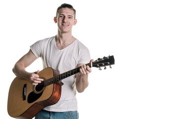 Music and creativity. Handsome young man in t-shirt playing on acoustic guitar. Horizontal frame