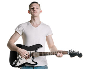 Music and creativity. A handsome young man in a T-shirt is holding an electric guitar. Horizontal frame