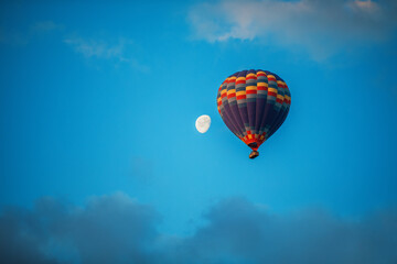 Hot air balloons flying over the valley at Cappadocia.