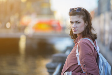 Fototapeta premium Pretty young woman at the river embankment