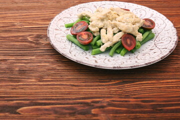 Tasty green beans with chicken meat and creamy sauce