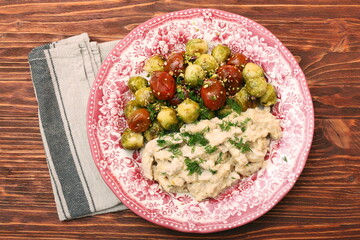 Tasty chicken meat under creamy sauce with brussels sprouts garn
