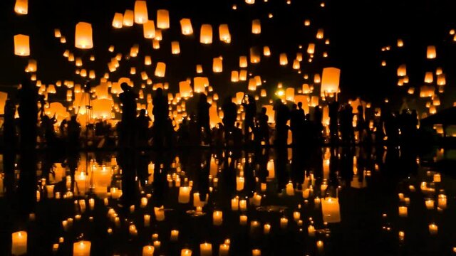 Many Sky Fire Lanterns Floating Up To The Sky In Yee Peng Lanna International 2016 And Reflection on Water Landmark Destination Travel Of Chiang Mai, Thailand