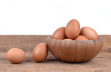 eggs in a wooden bowl on wooden floor
