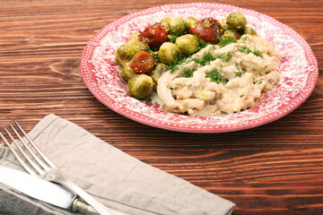 Tasty chicken meat under creamy sauce with brussels sprouts garn