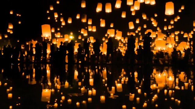 Many Sky Fire Lanterns Floating Up To The Sky In Yee Peng Lanna International 2016 And Reflection on Water Landmark Destination Travel Of Chiang Mai, Thailand (zoom out)