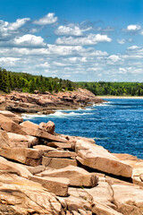 Acadia National Park dramatic rocky coastline. Maine, USA. Popular Sand Beach is in the distance.