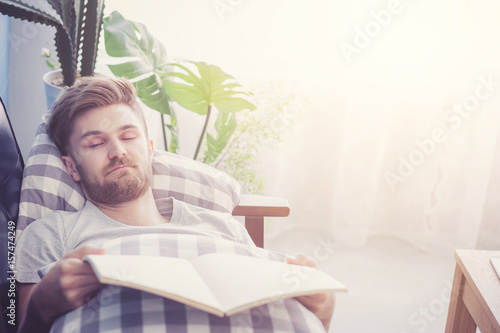 Man Reading Book With Holding Hand Sleep In Couch Sofa Stock