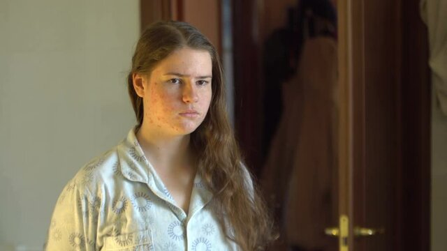Sad girl looking in the mirror