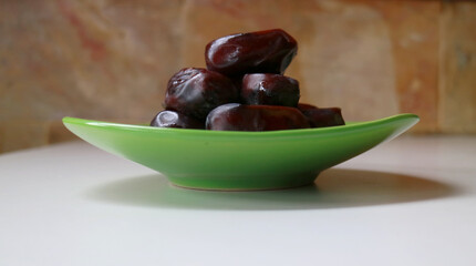 Dates palm fruit on the plate.