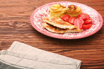 Fried turkey fillets, roasted potatoes and cherry tomato