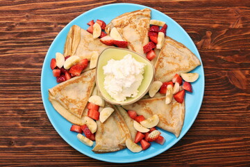 Delicious pancake with sliced of strawberry and banana