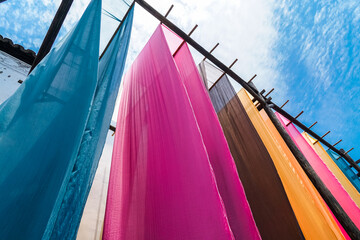 colorful fabric hanging to dry after traditional dye process,shot in Heng Dian Town,Zhejiang province of China.