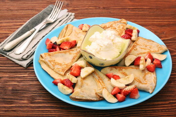 Delicious pancake with sliced of strawberry and banana