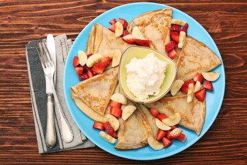 Delicious pancake with sliced of strawberry and banana