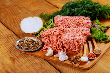 fresh raw ground beef on a paper on rustic wooden table