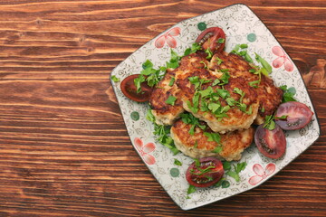 Chicken cutlets on wooden background