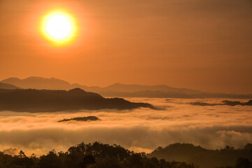 Fototapeta na wymiar Sea of mist in between mountains