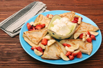 Delicious pancake with sliced of strawberry and banana