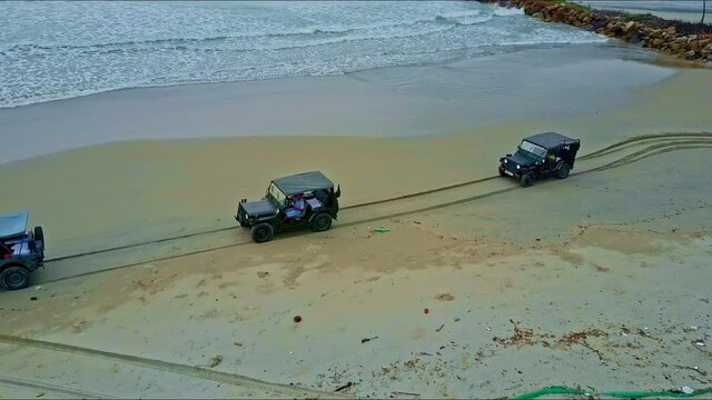 Aerial View Military Jeeps Drive along Sand Ocean Beach