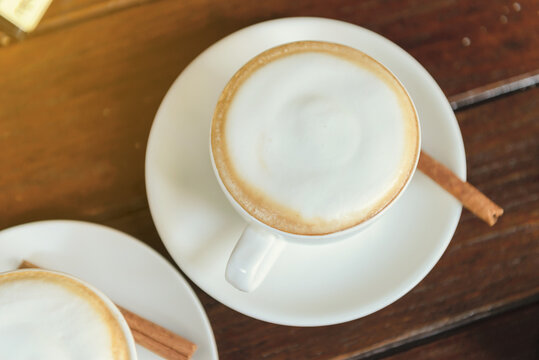 Top View Of Hot Coffee Cappuccino Cup With Milk Foam On Wood Table