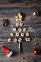 Christmas Gingerbread cookies in the shape of Christmas tree on the wooden texture background