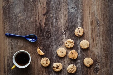 Coffee cup ,cookie and the opened book on wooden table background,copy space