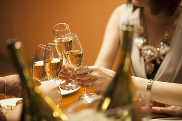 The women are drinking with a champagne at a luxurious restaurant