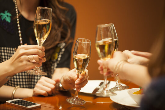 Four women are drinking in a luxurious restaurant with champagne
